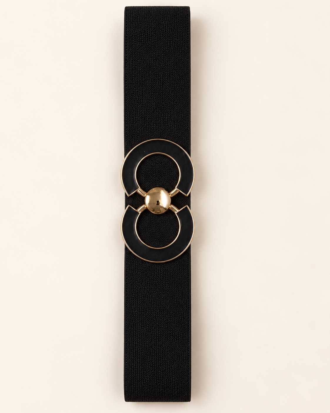 Ceinture ORIANE noire, bande élastique et boucle double cercle à contours dorés, vue à plat sur fond beige.